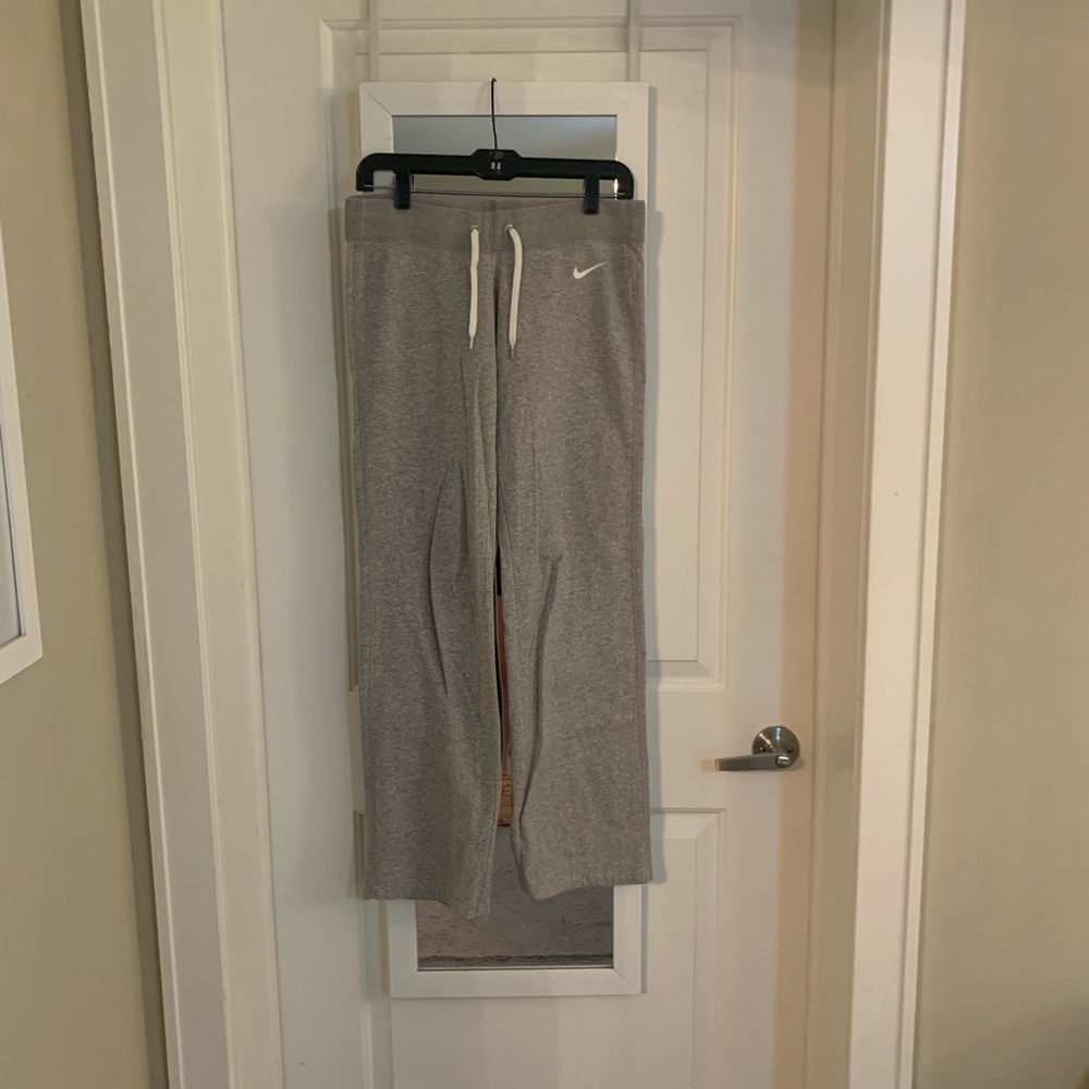 Gray Nike sweatpants with drawstring. No elastic at the bottom of the pants.
